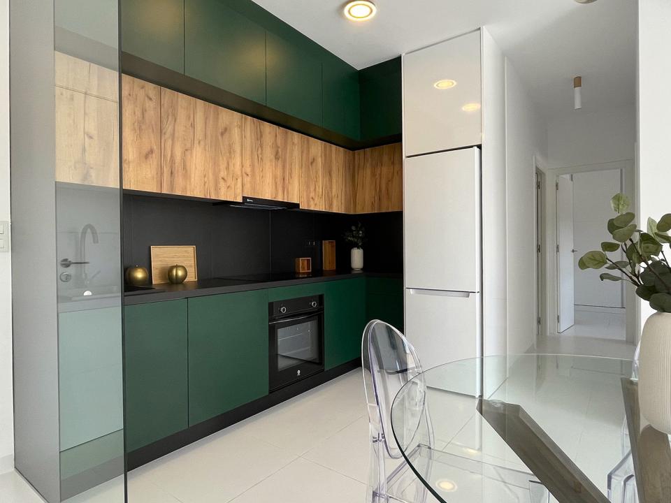 A modern kitchen connected to a spacious living room